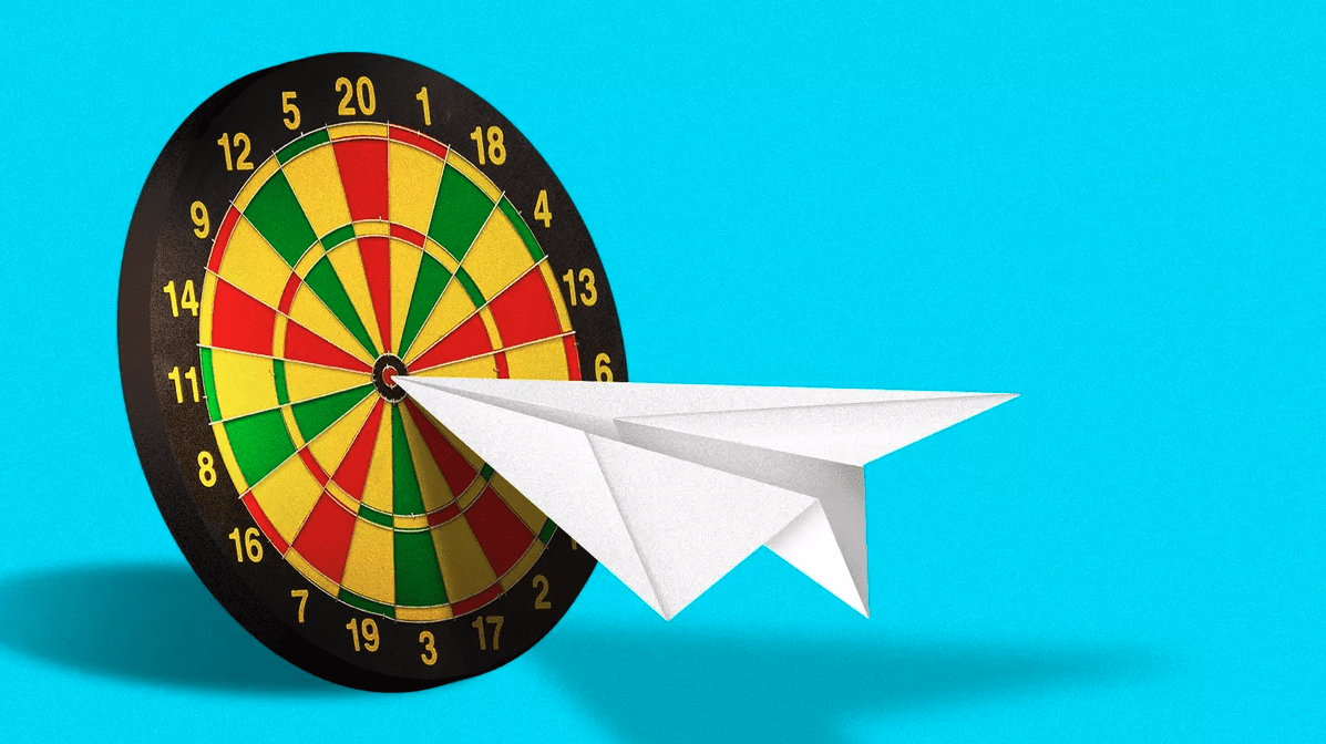 a paper airplane hitting a bullseye